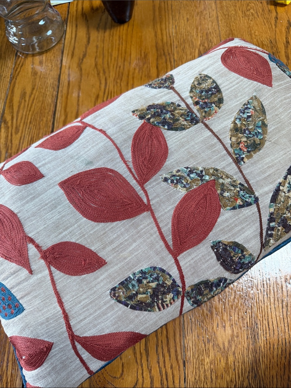 Unbranded linen lumbar pillow.  Tan, rust and multicolor leaves.  Zip cover.